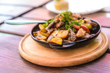 Fried ostrich on a frying pan