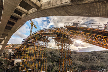 Construction of a bridge with cranes in the expansion works of the Madrid - Segovia - Valladolid highway. Fundamental axis of communications