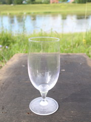 a glass of wine on a table in the open air