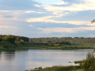 picturesque banks of the river in the summer evening