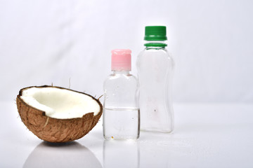 Coconut oil with coconut on white background.