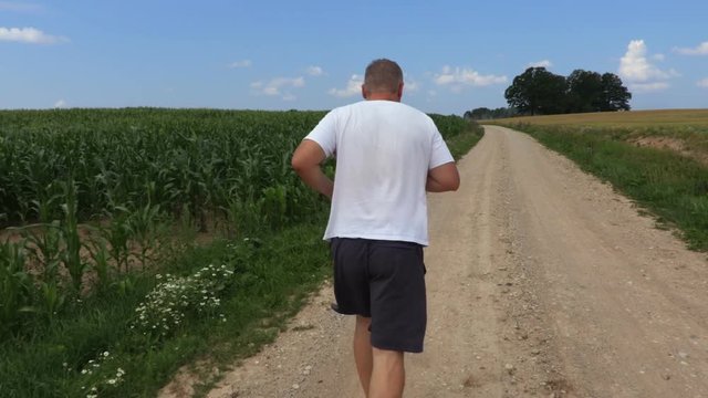 Camera follow runner on rural road