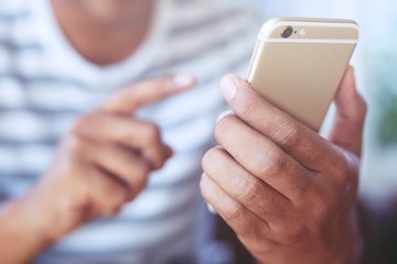 Young male using on cell phone during rest in office. sitting in watching message on mobile phone during break.