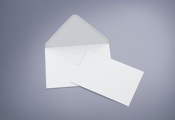 Opened envelope with blank card. Blank envelope with post card on dark background.