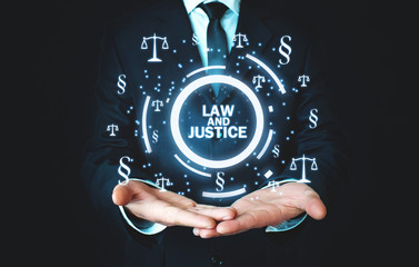 Man holding Justice Scales and Paragraph symbols. Law and Justice concept