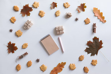 Flat lay, top view of vintage autumn woman office table desk. Workspace with laptop, maple leaves and flowers, diary on white background. Online shopping concept