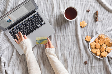 Top view of woman hands holding credit card on autumn baclground, business concept, online...
