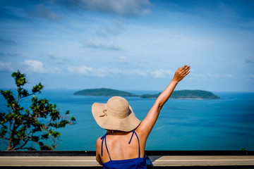 Happy Women tourists wear Blue dress at Must See View Point Chumphon, Thailand, Tourists sea view  From the high angle