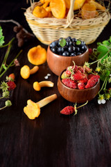 Strawberries, blueberries and chanterelles. Freshly picked forest berries and mushrooms