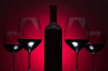 Glasses and bottle of red wine.