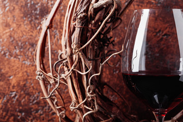 Dried vine and  glass of red wine.