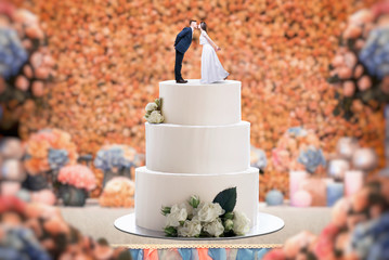 Wedding cake with bride and groom on the top