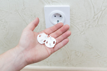 Electricity outlet on house wall covered with safety plugs and protection from baby and child....