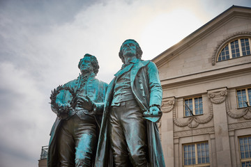 Fototapeta na wymiar Famous sculpture of Goethe and Schiller in the city of Weimar in Germany / Most famous classical german authors / 18th century