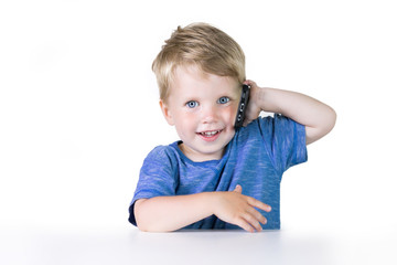 Kids education, developing, technology, mobile phone and internet concept, little child boy using smartphone on white background