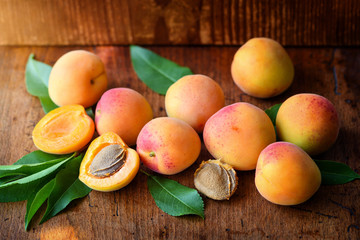 Ripe apricots on the old wooden background