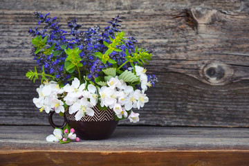 Bouquet of spring flowers on an old wooden background