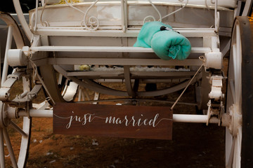 A white pumpkin carriage with a sign reading 