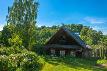 An old wooden house, gone through the window to the ground, Russia.