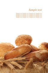 A lot of different breads are on sackcloth. isolate