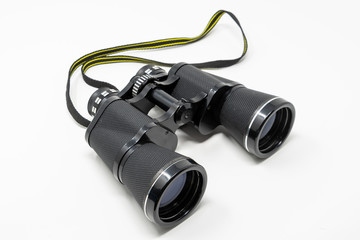 A set of old binoculars set against a white background
