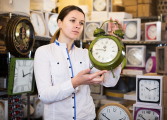 Woman choosing wall clock