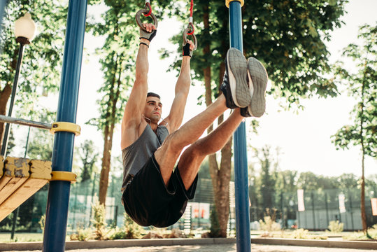 Man doing exercise on press using horizontal bar