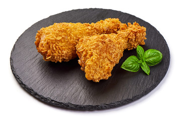 Breaded crispy fried chicken legs, isolated on white background.