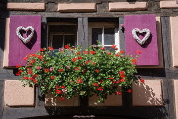 Fototapeta na wymiar Gingerbread-style house in the village of Riquewihr, Alsace, France