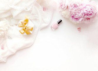 Soft white and pink flatlay with peonies.