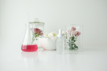 cosmetic skincare beauty product .natural organic flower oil ingredient in the laboratory. packaging spa concept.