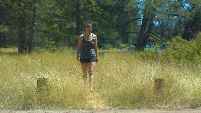 A Woman Walking Towards the Camera Through Wheat Next to the Deschutes River