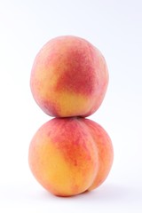 Peaches on a white background, two peaches isolated, orange nectarine close-up, blank for a designer, vegetarian food for breakfast, orange fruit for juice