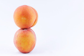 Peaches on a white background, two peaches isolated, orange nectarine close-up, blank for a designer, vegetarian food for breakfast, orange fruit for juice