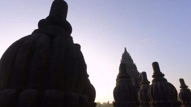 Moving cinematic shot of Prambanan Temple & it stupa revealing sun rising behind it