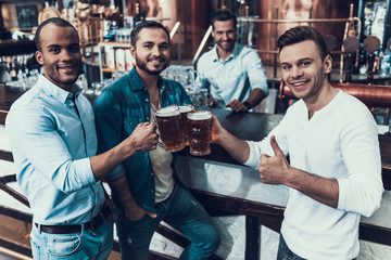 Smiling Young Men Drinking Beer and Have Fun.