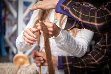 Women spinning yarn from Alpaca fiber at the farmers market