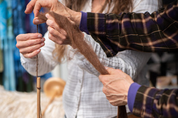 Women spinning yarn from Alpaca fiber at the farmers market