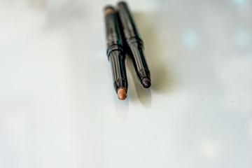 Close-up of automatic eyebrow pencils, on white background, different colors to achieve perfect results.Shallow depth of focus. Concept fashion and beauty.