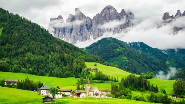 Time lapse of the clouds on the mount Geissler Spitzen behind the Church of St. Magdalena in Val di Funes Valley at South Tyrol Italy