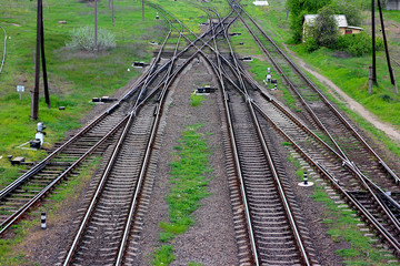 Obraz premium Railway, the top view on rails. Leading parallel steel rails with regular crossbars. Abstract geometric view.