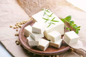 tofu cheese in wooden plate and herb on top