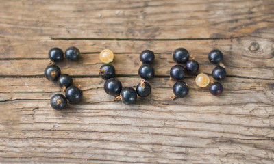 berry font. word sun from berries on a wooden background