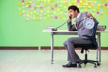 Businessman with many conflicting priorities in time management 