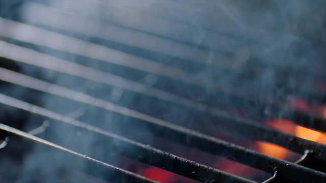 Close up of grill ready with fire flames, slow motion