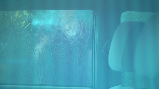 Woman Washing Her Car Rinsing Off the Window.  Shot on a Blackmagic Ursa Mini Pro 4.6k with a Sigma 50-100mm f/1.8.