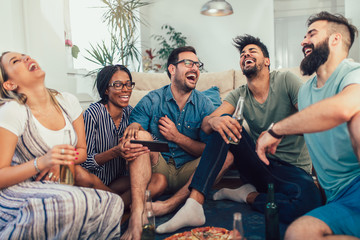 Group of young friends eating pizza.Home party.Fast food concept.