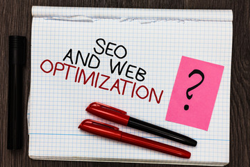 Word writing text Seo And Web Optimization. Business concept for Search Engine Keywording Marketing Strategies Color pen on written notepad with question mark black marker on woody deck.