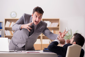 Angry boss shouting at his employee