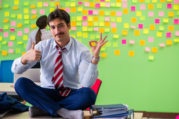 Man and woman in the office with many conflicting priorities in 